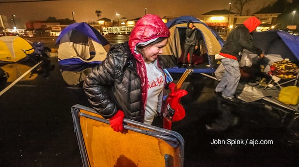 The rain did not stop Christina Sanchez from camping outside the new Chick-fil-A at North Druid Hills and Briarcliff roads. Her efforts were rewarded. She secured the first spot in line and received free meals for a year.  JOHN SPINK / JSPINK@AJC.COM