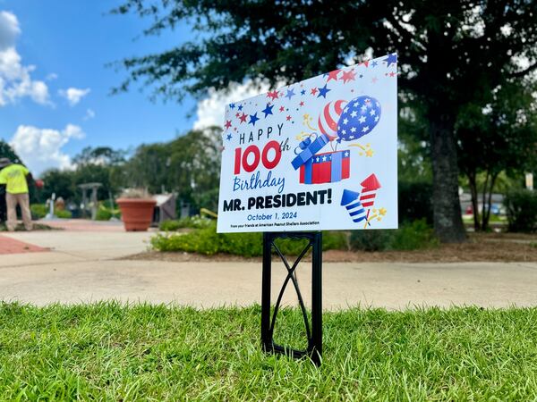 A sign posted in downtown Plains for the 100th birthday of former President Jimmy Carter.