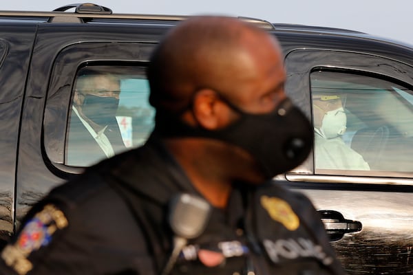 President Donald Trump wears a protective face mask in a motorcade outside Walter Reed Medical Center during his treatment for COVID-19 in October.