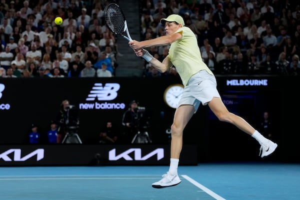 Jannik Sinner of Italy plays a backhand return to Ben Shelton of the U.S. during their semifinal match at the Australian Open tennis championship in Melbourne, Australia, Friday, Jan. 24, 2025. (AP Photo/Ng Han Guan)