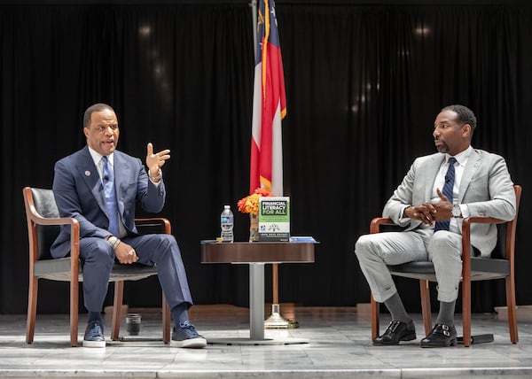 Operation HOPE CEO John Hope Bryant, from left, and Atlanta Mayor Andre Dickens sit down for a discussion during the kick off the national “American Aspiration Tour,” highlighting the importance of financial literacy Thursday, July 25, 2024 at Atlanta City Hall. The event also unveiled the Business Plan for America, positioning Atlanta as the national model. (Jenni Girtman for The Atlanta Journal-Constitution)