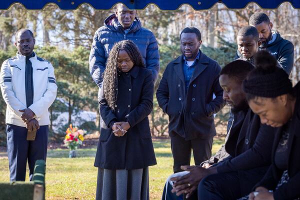 Mourners for Maëlla Hope Makongote, who was born and died on Dec. 18, gather for a service conducted as part of the Fulton County indigent burial program at Lakeside Cemetery in Palmetto on Thursday, December 28, 2023. (Arvin Temkar / arvin.temkar@ajc.com)