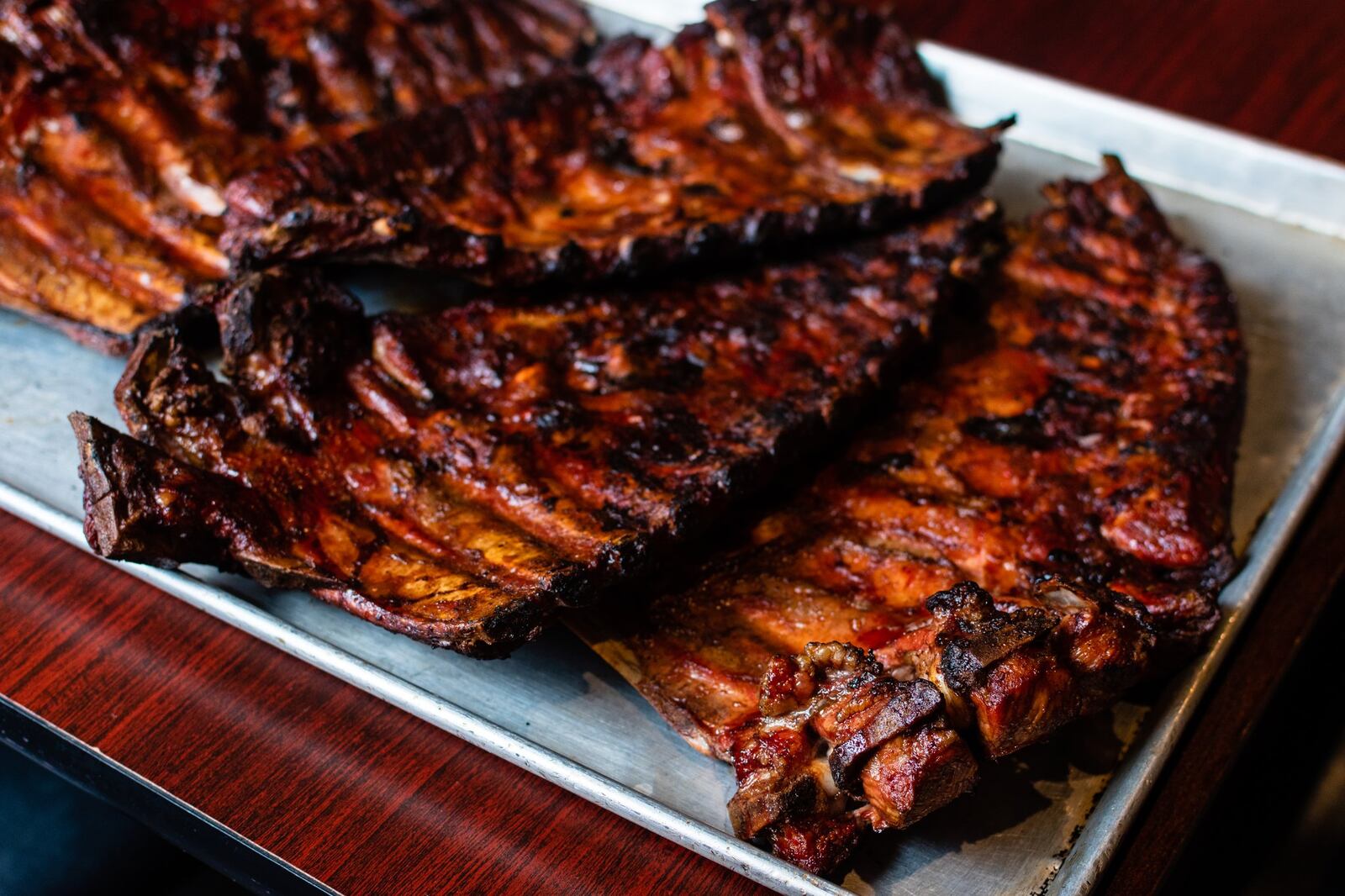 A tray full of ribs fresh out of the pit at Dreamland in Duluth’s Parsons Alley, delivered by pitmaster Raymon Dennis, who said, "I love my job." CONTRIBUTED BY HENRI HOLLIS