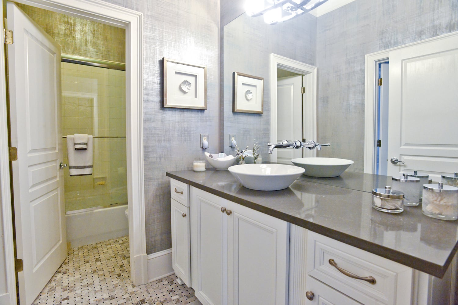 Gray and white colors throughout the guest bathroom