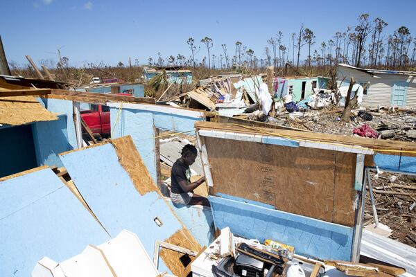 Kristina Orlince sits in a destroyed home in the community of Farm Road Sept. 9, 2019, in Great Abaco, Bahamas. The few Haitians that decided to stay in hurricane-devastated Great Abaco Island struggle to survive with the little help they receive from foreign aid agencies. Hurricane Dorian hit the island chain as a Category 5 storm, battering them for two days before moving north. JOSE JIMENEZ / GETTY IMAGES