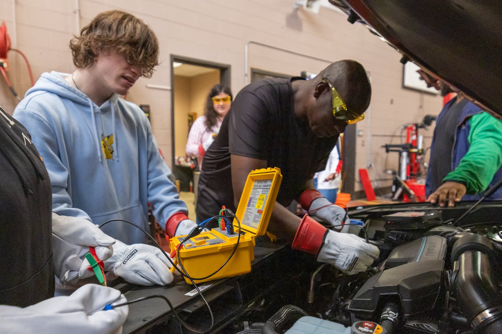 Luke Castle and Bob Jones does a diagnostic test on the engine of a car at Savannah Technical College on Tuesday, July 16, 2024 in Savannah, GA. (AJC Photo/Katelyn Myrick)