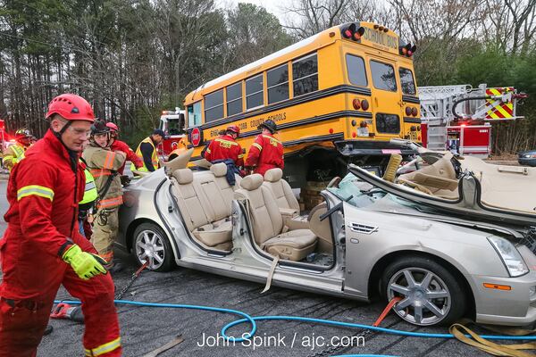 A driver was injured in a school bus crash Tuesday on Austell Road in Cobb County. (JOHN SPINK / JSPINK@AJC.COM)