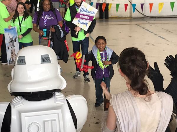  Khairi Brown, who has leukemia, is greeted at the hangar by "Star Wars" characters. CREDIT: Rodney Ho/rho@ajc.com