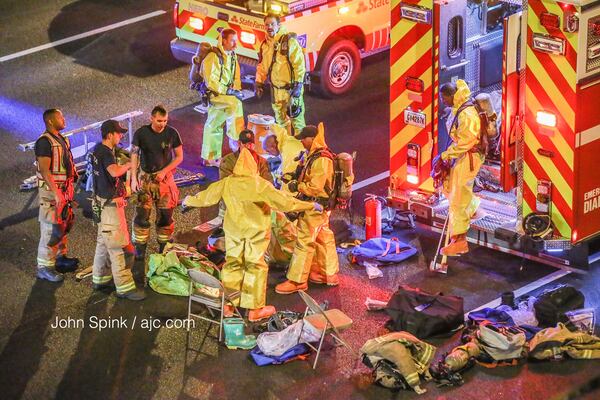 A crash and chemical spill temporarily shut down both directions of the Downtown Connector at 10th Street. JOHN SPINK / JSPINK@AJC.COM