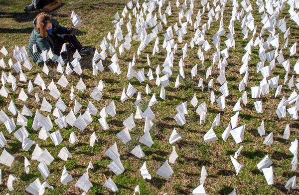 Volunteers plants some of the 15,000 flags on the lawn of First Christian Church of Decatur on Saturday, February 20, 2021. The flags represent the number of COVID-19 deaths in Georgia, and the effort aims to raise awareness about the toll of the coronavirus. (Photo: Steve Schaefer for The Atlanta Journal-Constitution)