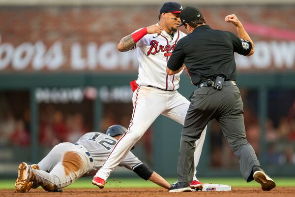 Umpire Ben May calls out New York Yankees Isiah Kiner-Falefa after Atlanta Braves Orlando Arcia makes the tag in the first inning of a baseball game Monday, Aug. 14, 2023, in Atlanta. (AP Photo/Hakim Wright Sr.)