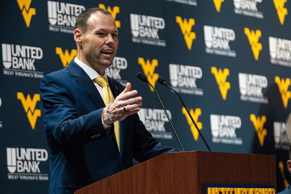 West Virginia's Athletic Director Wren Baker introduces new West Virginia football coach Rich Rodriguez speaks during an NCAA college football news conference Friday, Dec. 13, 2024, in Morgantown, W.Va. (Benjamin Powell/The Dominion-Post via AP)