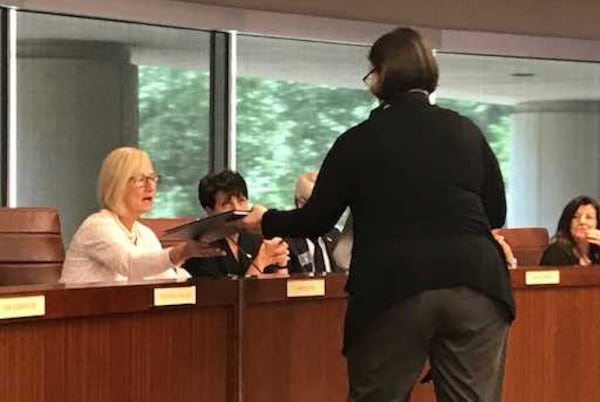 Leslie Bass, a recent graduate of Gwinnett Technical College's commercial photography program, gives information to Technical College System of Georgia board chairwoman Anne Kaiser about the program. ERIC STIRGUS / ESTIRGUS@AJC.COM