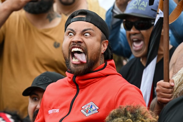 A protester reacts outside New Zealand's parliament during a demonstration against a proposed law that would redefine the country's founding agreement between Indigenous Māori and the British Crown, in Wellington Tuesday, Nov. 19, 2024. (AP Photo/Mark Tantrum)