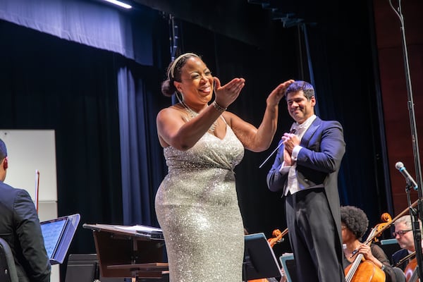 Soprano soloist Maria Clark and conductor Paul Bhasin revel onstage with the DeKalb Symphony Orchestra. Photo: Jeff Alperin