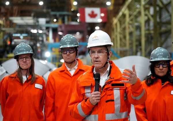 Canadian Prime Minister designate Mark Carney, second right, speaks to steel workers after touring the ArcelorMittal Dofasco steel plant in Hamilton, Ont., on Wednesday, March 12, 2025. (Nathan Denette /The Canadian Press via AP)