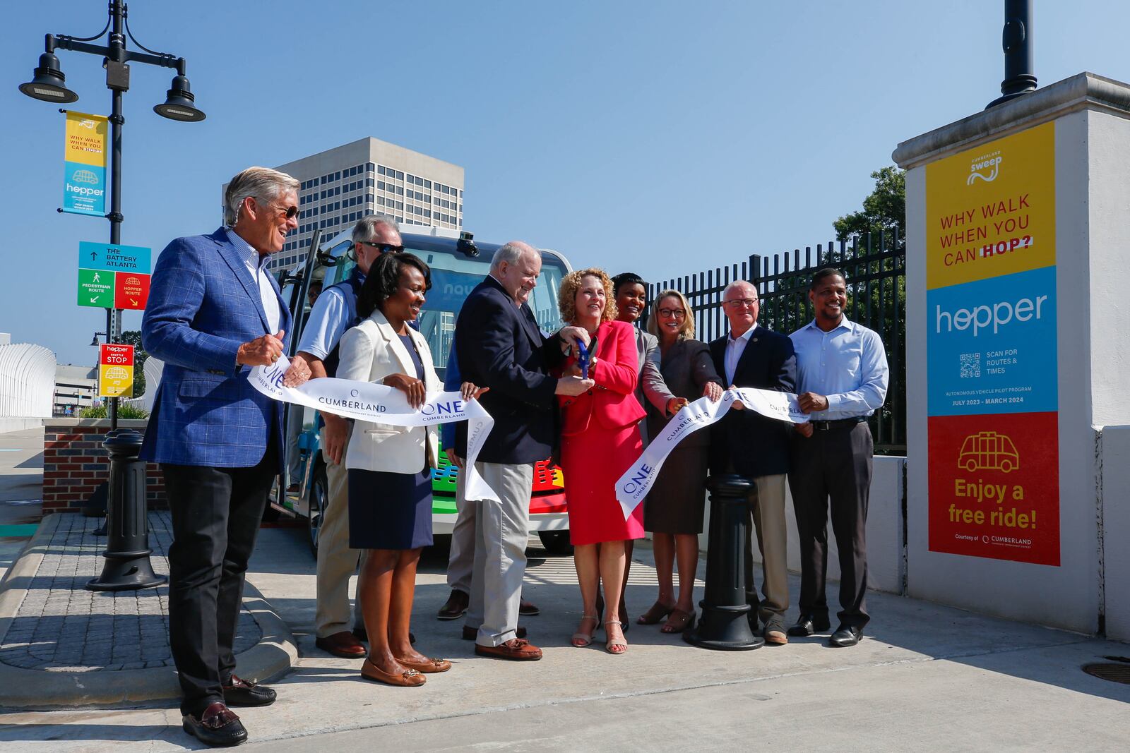 Leaders of the sweep project cut the ribbon at the unveiling of the Cumberland Hopper in Atlanta on Tuesday, July 25, 2023. (Katelyn Myrick/katelyn.myrick@ajc.com)