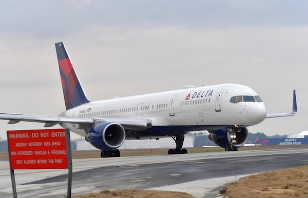 In this file photo, a Delta jet prepares to take off at Hartsfield-Jackson International Airport. HYOSUB SHIN / HSHIN@AJC.COM