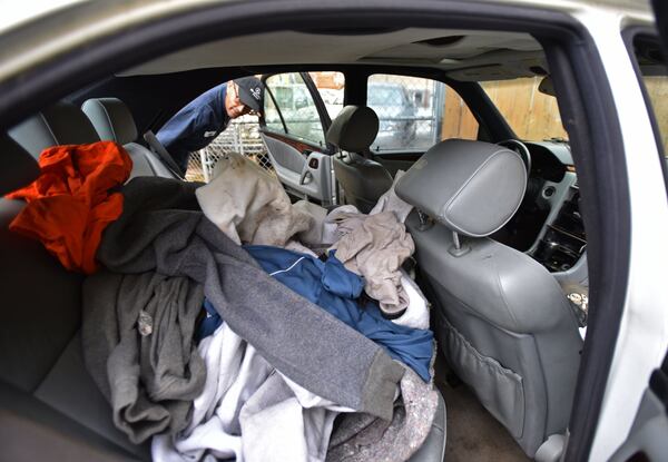 April 6, 2017, Atlanta — Menge Gizachew, owner of GT Auto Repair, shows a broken-down Mercedes that he let Basil Eleby sleep in near the sections of I-85 that burned and collapsed in 2017. Eleby was accused of starting the fire under the I-85 overpass. HYOSUB SHIN / HSHIN@AJC.COM