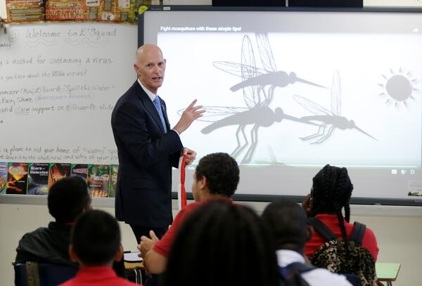 Florida Gov. Rick Scott tells students mosquitoes are now the size of large birds of prey. (AP Photo)