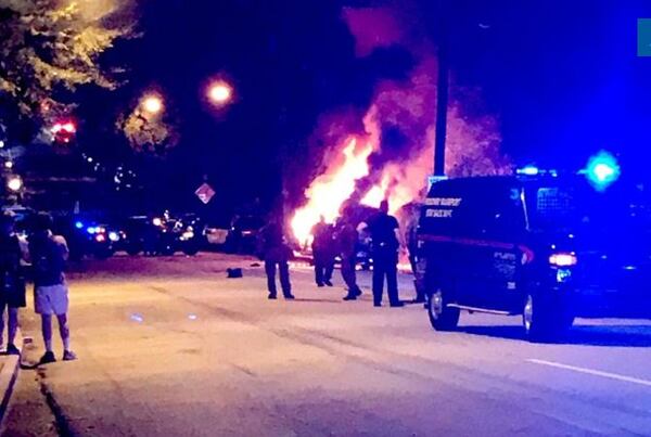  A police car is set afire near the Georgia Tech police station Monday night. Photo: Nelson Helm/AJC