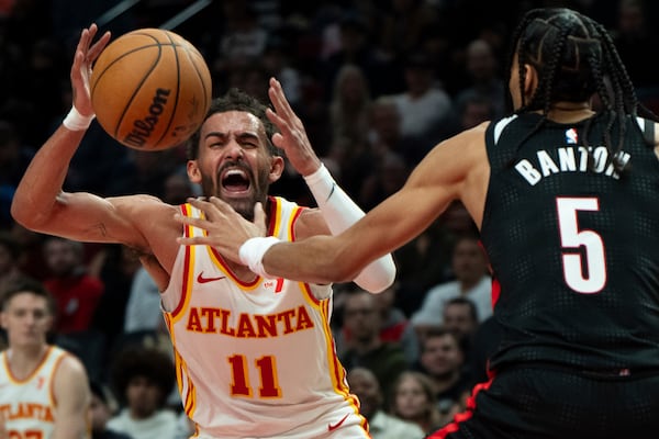 Atlanta Hawks guard Trae Young (11) is fouled as Portland Trail Blazers guard Dalano Banton (5) defends during the first half of an NBA basketball game Sunday, Nov. 17, 2024, in Portland, Ore. (AP Photo/Jenny Kane)