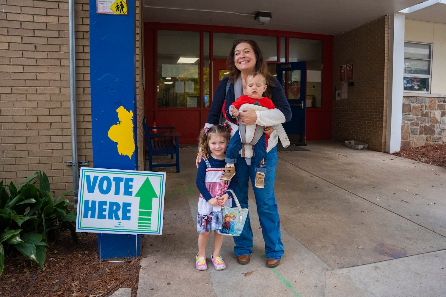 Katie Phillips and her son and daughter dressed in red white and blue for election day at a polling site in Chamblee,  Tuesday, Nov. 5, 2024. (Olivia Bowdoin for the AJC). 