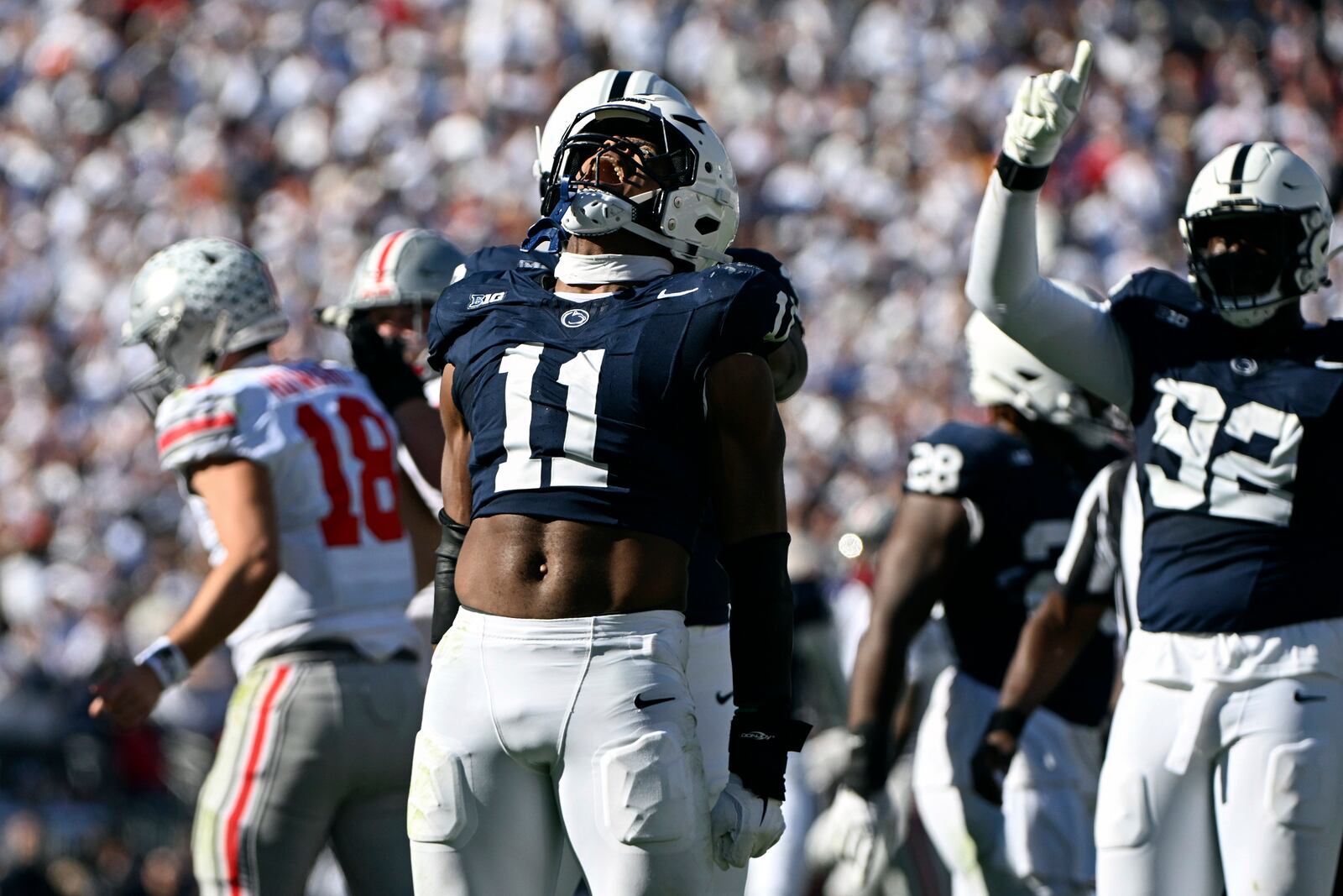 Penn State defensive end Abdul Carter (11) celebrates after sacking Ohio State quarterback Will Howard (18) during the second quarter of an NCAA college football game, Saturday, Nov. 2, 2024, in State College, Pa. (AP Photo/Barry Reeger)