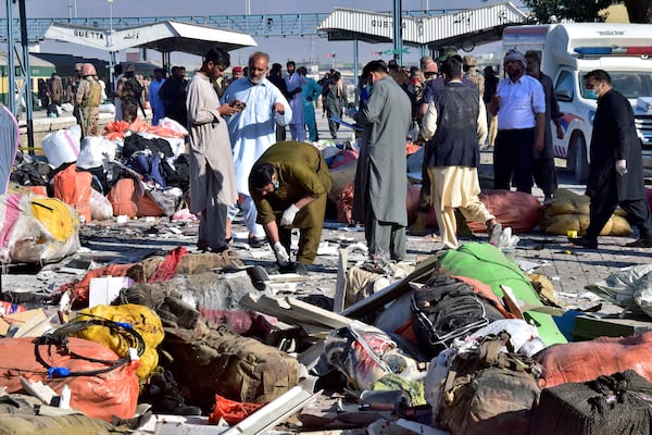 Investigators collect evidences from the site of a bomb explosion at railway station in Quetta, southwestern Pakistan, Saturday, Nov. 9, 2024. (AP Photo/Arshad Butt)