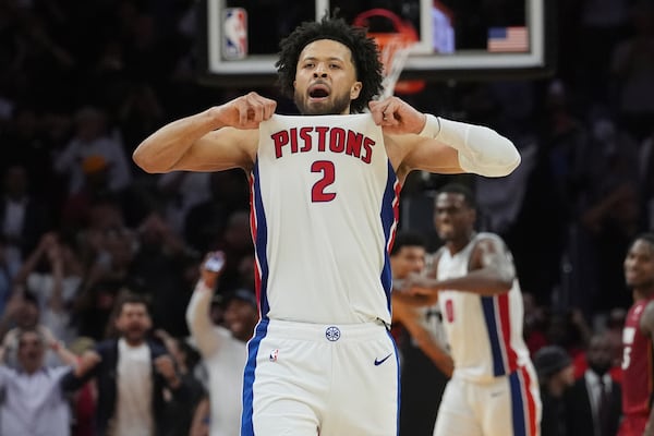 Detroit Pistons guard Cade Cunningham (2) celebrates after scoring the winning basket during the second half of an NBA basketball game against the Miami Heat, Wednesday, March 19, 2025, in Miami. (AP Photo/Marta Lavandier)