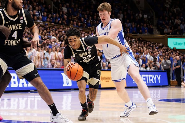 Wake Forest's Hunter Sallis (23) drives past Duke's Kon Knueppel, right, during the first half of an NCAA college basketball game in Durham, N.C., Monday, March 3, 2025. (AP Photo/Ben McKeown)