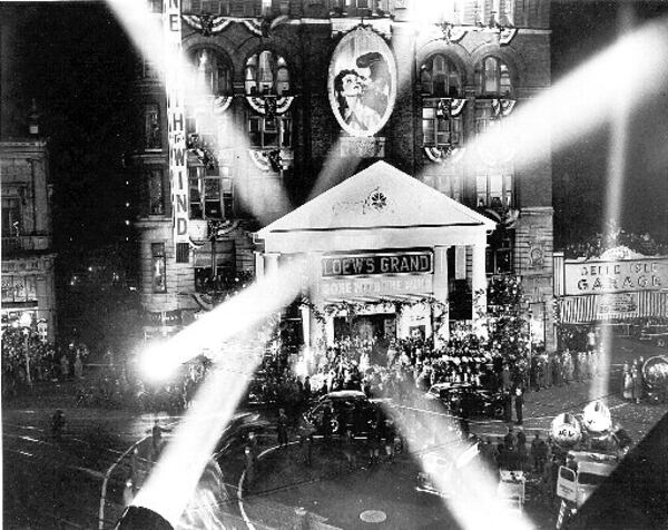 391215 - ATLANTA, GA -- Spotlights add to the excitement that reigned in front of Atlanta's Loew's Grand theater for the Friday night, December 15, 1939 premiere of the Civil War epic film 'Gone With The Wind.' (AJC Staff Photo)