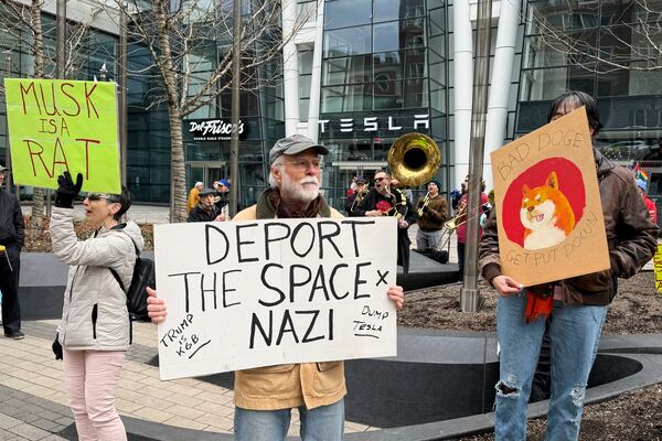 Protesters rally outside of a Tesla store in Boston, Saturday, March 1, 2025, against the company's CEO, Elon Musk, who is leading an effort to cut government jobs on behalf of President Donald Trump. (AP Photo/Rodrique Ngowi)