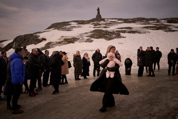 Relatives and friends of Salik and Malu Schmidt wait outside the Church of our Savior during their weeding in Nuuk, Greenland, Saturday, Feb. 15, 2025. (AP Photo/Emilio Morenatti)