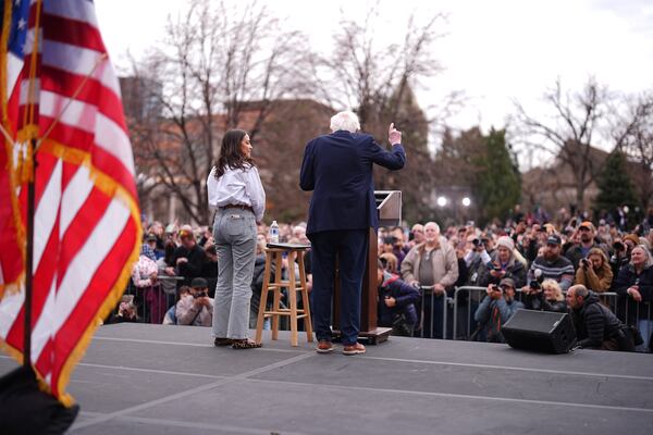 Sen. Bernie Sanders, I-Vt., right, speaks as Rep. Alexandria Ocasio-Cortez, D-N.Y., looks on during a stop of their "Fighting Oligarchy" tour that filled Civic Center Park, Friday, March 21, 2025, in Denver. (AP Photo/David Zalubowski)