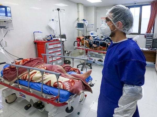 A nurse cares for patients in a ward dedicated for people infected with the coronavirus, at Forqani Hospital in Qom, 78 miles south of the capital Tehran, Iran.