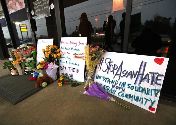 A memorial grows larger by the hour outside Young’s Asian Massage in Acworth on March 17, 2021. Four people were killed at the spa by a gunman. Eight people were found dead at three different spas in the Atlanta area Tuesday by suspected killer Robert Aaron Long with the shooting spree beginning at Young’s Asian Massage. (Curtis Compton / Curtis.Compton@ajc.com)