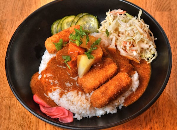 Curry Rice Bowl with Tenya fried tofu sticks, pickled red radish, sesame seeds and Japanese slaw. You also can get this dish with brined chicken tenders instead of the fried tofu. (Chris Hunt for The Atlanta Journal-Constitution)