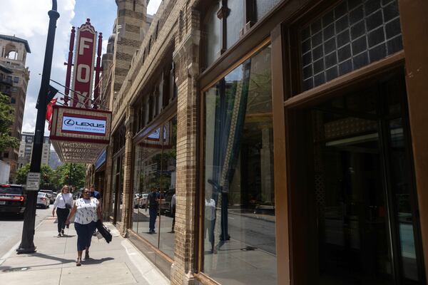 Pedestrians walk pass the Fox Theater on Peachtree on Wednesday, July 12, 2023 in Atlanta. (Michael Blackshire/Michael.blackshire@ajc.com)