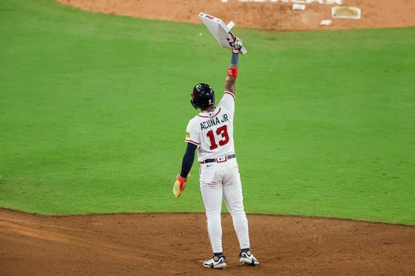 Atlanta Braves’ Ronald Acuna Jr. (13) holds up second base after he stole his 70th base of the season during the 10th inning against the Chicago Cubs at Truist Park, Wednesday, September 27, 2023, in Atlanta. (Jason Getz / Jason.Getz@ajc.com)