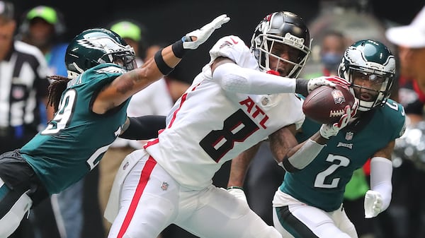 Falcons rookie tight end Kyle Pitts makes a reception against a double team by Philadelphia Eagles defenders during the fourth quarter Sunday, Sept. 12, 2021, at Mercedes-Benz Stadium in Atlanta. (Curtis Compton / Curtis.Compton@ajc.com)