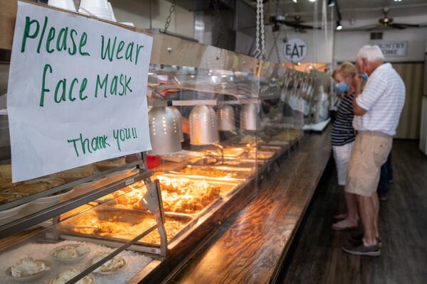 200717-Tucker-Sheets of acrylic separate the food from the hungry lunch crowd at Matthews Cafeteria on Main Street in Tucker on Friday afternoon July 17, 2020. The dining institution, established in 1955, ask customers to wear masks, added the acrylic dividers, made separate entrance and exit doors and have drive-up service.  Ben Gray for the Atlanta Journal-Constitution