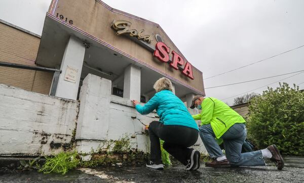 Dan and Charlotte Hayes drove from Sandy Springs to leave flowers and pray in front of the Gold Spa.