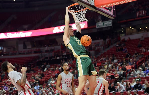 Colorado State center Nikola Djapa (23) dunks against UNLV during the first half of an NCAA basketball game Saturday, Feb. 22, 2025, in Las Vegas. UNLV players from left: forward Jeremiah Cherry, guards Jaden Henley and Julian Rishwain. (Steve Marcus/Las Vegas Sun via AP)