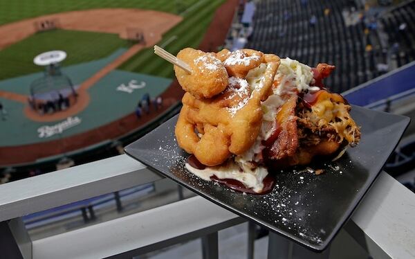 The Pulled Pork Patty Melt is seen at Kauffman Stadium before a baseball game between the Kansas City Royals and the Chicago White Sox on Tuesday, May 2, 2017, in Kansas City, Mo. The sandwich features pulled pork with cheese, bacon and cole slaw between a funnel cake bun and is topped with a jalapeno. (AP Photo/Charlie Riedel)