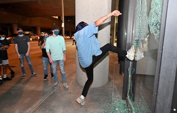 May 30, 2020 -  Atlanta - Protesters attacking Police Zone 5 downtown.  Small groups of people roam the streets  after curfew Saturday, some vandalizing property, as protests began for a second day.  Protests over the death of George Floyd in Minneapolis police custody spread around the United States on Saturday, as his case renewed anger about others involving African Americans, police and race relations.     Hyosub Shin / hyosub.shin@ajc.com