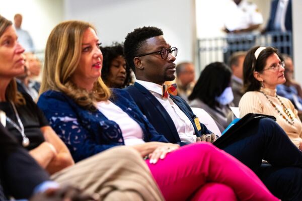 DeKalb school board members Allyson Gevertz (from left), Anna Hill, Diijon DaCosta (the board chair) and Whitney McGinniss watch a public town hall meeting featuring DeKalb superintendent finalist Devon Horton at Chamblee High School in Chamblee on Wednesday, April 12, 2023. (Arvin Temkar / arvin.temkar@ajc.com)