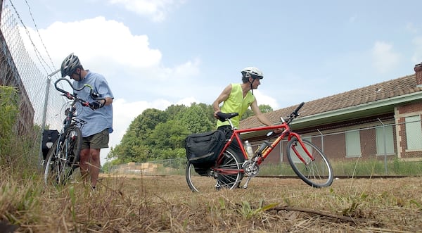 The caption on this 2004 file photo read: "The Belt Line is proposed to intersect this site at the old train depot at Memorial Drive and the Glenwood Connector. These two bike riders attended prepare to cycle away from the press conference site and are (left to right) Kevin Whited and Dennis Hoffarth. Both are sympathetic to the Atlanta Bicycle Campaign and are avid city bikers."