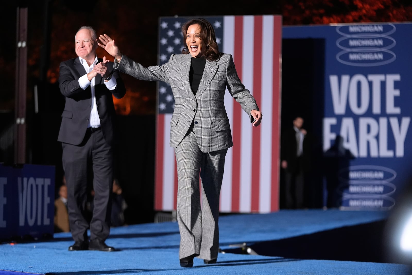 Democratic presidential nominee Vice President Kamala Harris, right, is greeted by her running mate Minnesota Gov. Tim Walz, as she arrives to speak at a campaign event in Burns Park Monday, Oct. 28, 2024, in Ann Arbor, Mich. (AP Photo/Paul Sancya)