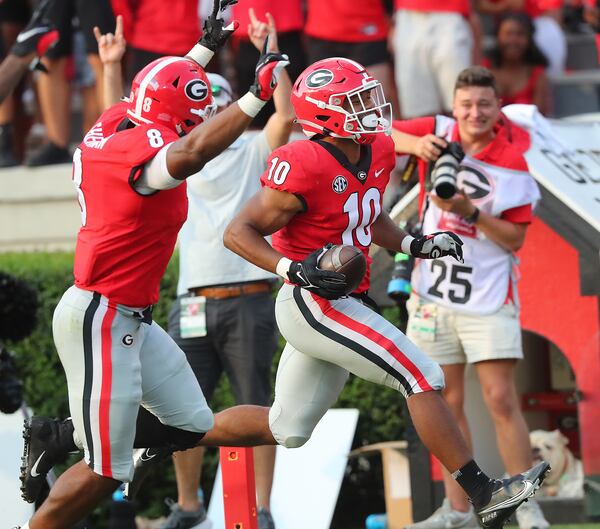 Georgia linebacker Jamon Dumas-Johnson returns an interception with MJ Sherman (left) cheering him on against UAB during the fourth quarter Saturday, Sept .11, 2021, in Athens. (Curtis Compton / Curtis.Compton@ajc.com)